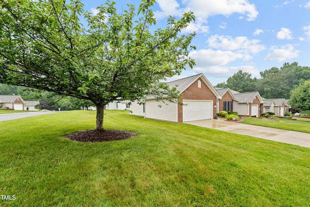 3027 Maple Unit T1, Burlington, NC 27215 - view of front facade with brick siding, a garage, concrete driveway, and a front yard