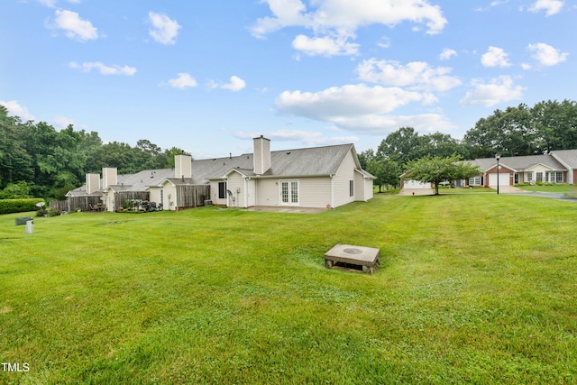 3027 Maple Unit T1, Burlington, NC 27215 - back of property featuring a yard, a patio, a chimney, and french doors