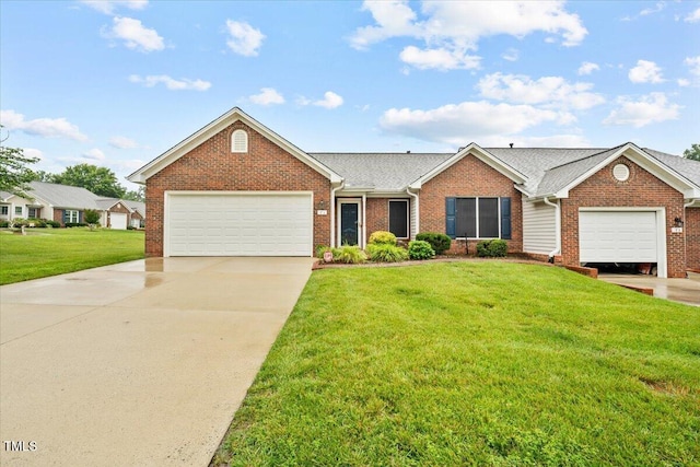 3027 Maple Unit T1, Burlington, NC 27215 - view of front of home featuring brick siding, a front yard, a garage, and concrete driveway