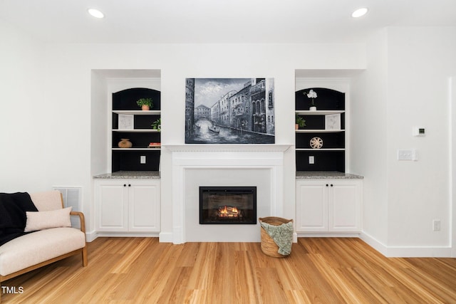 2001 Turtle Point Dr, Raleigh, NC 27604 - living area featuring light wood-style flooring, a glass covered fireplace, built in shelves, and recessed lighting