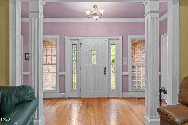 414 Bakewell Ct, Wake Forest, NC 27587 - entryway featuring ornate columns, light wood-style floors, crown molding, baseboards, and a chandelier