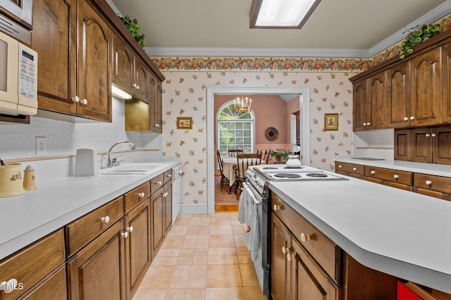 414 Bakewell Ct, Wake Forest, NC 27587 - kitchen with white appliances, wallpapered walls, a sink, light countertops, and baseboards