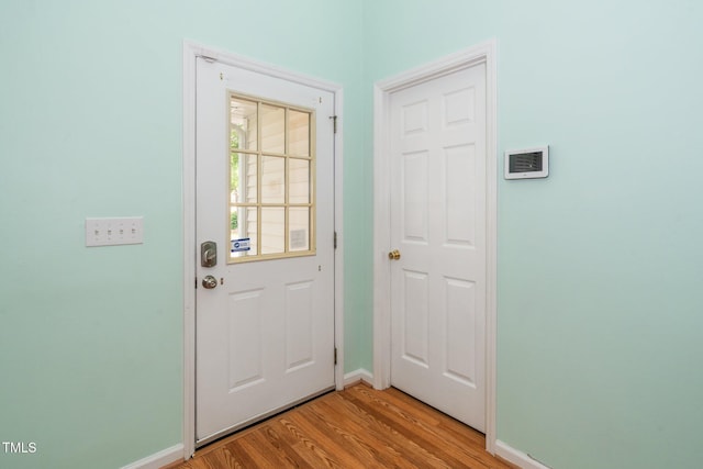5006 Silhouette Dr, Durham, NC 27713 - doorway with baseboards and light wood-style flooring