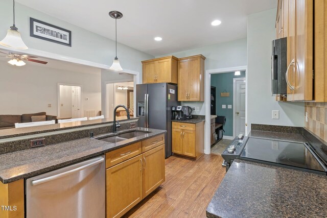 395 Timberlands Dr, Louisburg, NC 27549 - kitchen featuring appliances with stainless steel finishes, a sink, light wood-style floors, decorative light fixtures, and recessed lighting