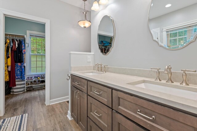 395 Timberlands Dr, Louisburg, NC 27549 - bathroom featuring double vanity, wood finished floors, baseboards, and a spacious closet