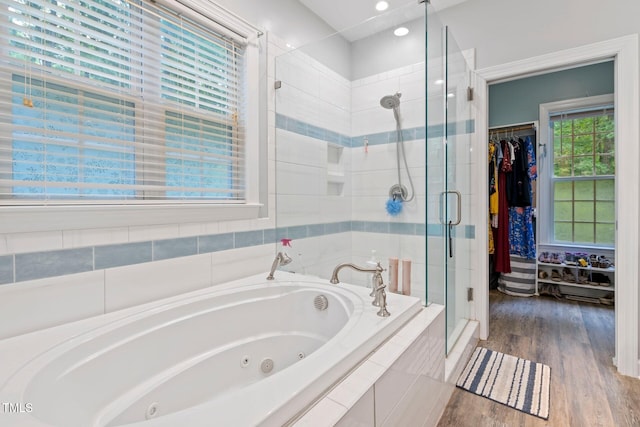 395 Timberlands Dr, Louisburg, NC 27549 - bathroom with a shower stall, a jetted tub, wood finished floors, a spacious closet, and recessed lighting