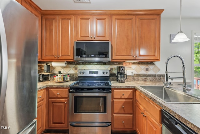 153 Hickory Nut Dr, Smithfield, NC 27577 - kitchen with stainless steel appliances, a sink, tasteful backsplash, brown cabinetry, and decorative light fixtures