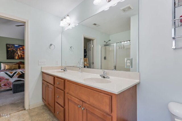 153 Hickory Nut Dr, Smithfield, NC 27577 - full bathroom featuring double vanity, ensuite bathroom, a shower with shower door, and tile patterned floors