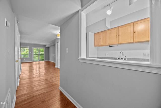 134 Kingsbury Dr, Chapel Hill, NC 27514 - hallway featuring wood finished floors, a sink, baseboards, and track lighting