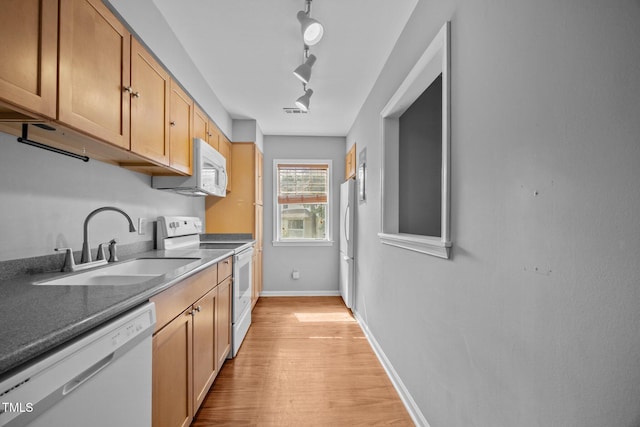 134 Kingsbury Dr, Chapel Hill, NC 27514 - kitchen with white appliances, a sink, light wood-style floors, rail lighting, and baseboards