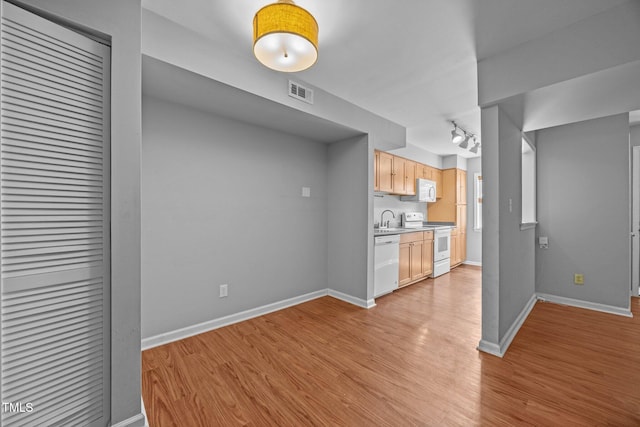 134 Kingsbury Dr, Chapel Hill, NC 27514 - kitchen featuring white appliances, a sink, light wood finished floors, light countertops, and light brown cabinetry