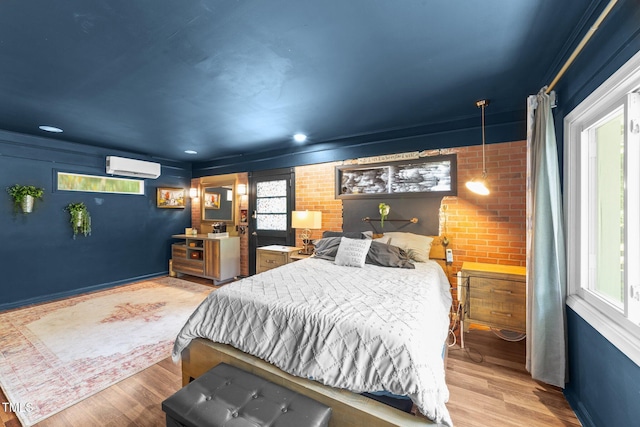 2005 Cole Mill Rd, Durham, NC 27712 - bedroom featuring an AC wall unit, wood finished floors, and brick wall