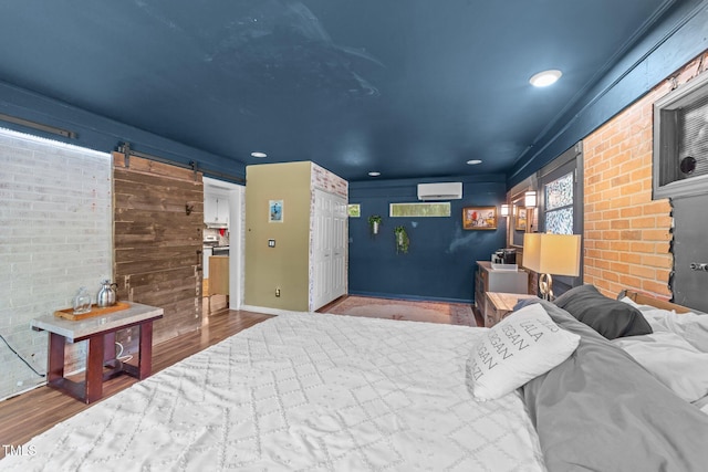 2005 Cole Mill Rd, Durham, NC 27712 - bedroom with a wall unit AC, wood finished floors, a barn door, recessed lighting, and brick wall