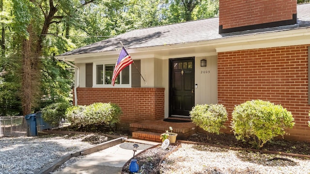 2005 Cole Mill Rd, Durham, NC 27712 - entrance to property featuring a chimney, brick siding, and roof with shingles