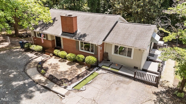 2005 Cole Mill Rd, Durham, NC 27712 - view of front of house featuring a chimney, brick siding, a shingled roof, and a gate