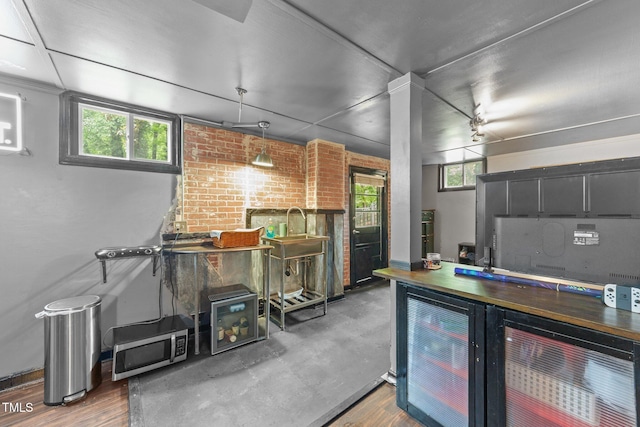 2005 Cole Mill Rd, Durham, NC 27712 - kitchen with stainless steel microwave, wood finished floors, and baseboards