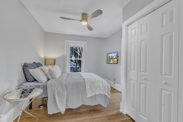 602 Dunbar St, Durham, NC 27701 - bedroom with wood finished floors, a closet, baseboards, and a ceiling fan