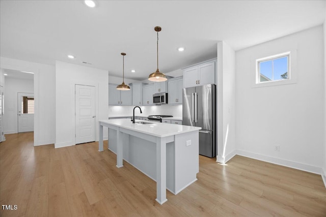 212 Aubey Ln, Wake Forest, NC 27587 - kitchen with stainless steel appliances, a sink, light countertops, backsplash, and light wood-type flooring