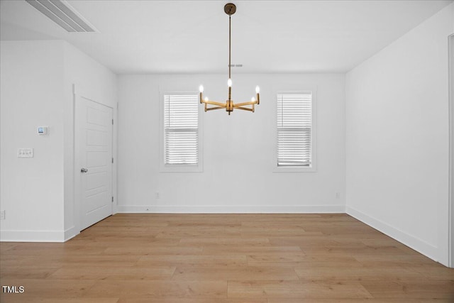 212 Aubey Ln, Wake Forest, NC 27587 - unfurnished dining area featuring a chandelier, light wood-style flooring, and baseboards