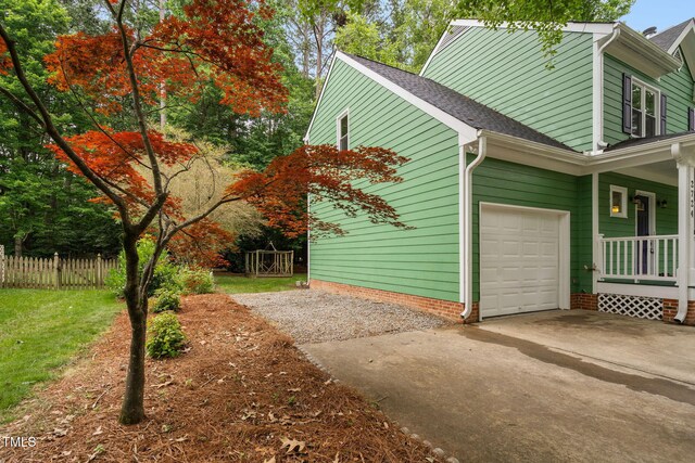 2724 Glastonbury Rd, Apex, NC 27539 - view of side of property with concrete driveway, roof with shingles, a porch, and a garage