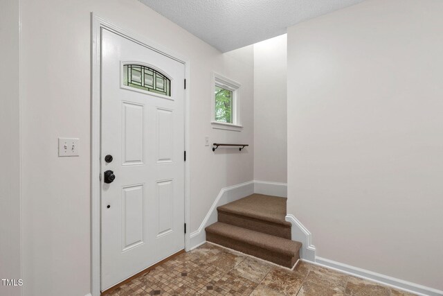 2724 Glastonbury Rd, Apex, NC 27539 - entryway with stairway, baseboards, and a textured ceiling