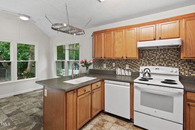 2724 Glastonbury Rd, Apex, NC 27539 - kitchen with white appliances, under cabinet range hood, a sink, decorative backsplash, and dark countertops
