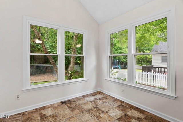 2724 Glastonbury Rd, Apex, NC 27539 - unfurnished room with baseboards, vaulted ceiling, and stone finish floors