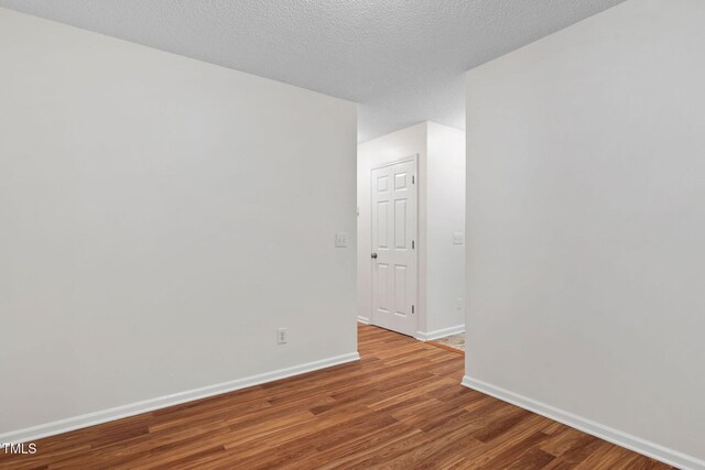 2724 Glastonbury Rd, Apex, NC 27539 - spare room featuring wood finished floors and baseboards