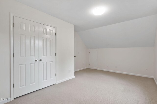 2724 Glastonbury Rd, Apex, NC 27539 - additional living space with light colored carpet, baseboards, and lofted ceiling