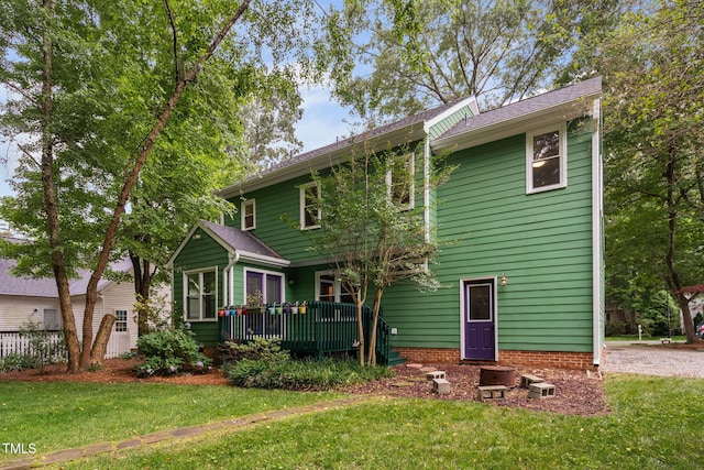 2724 Glastonbury Rd, Apex, NC 27539 - back of property with a deck and a lawn