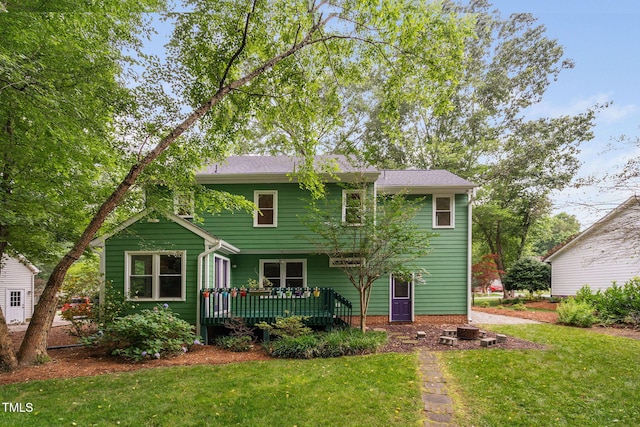 2724 Glastonbury Rd, Apex, NC 27539 - view of front of home with a wooden deck and a front lawn