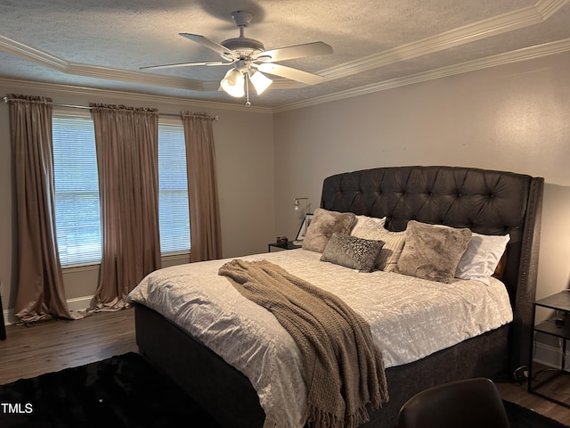 7832 Shuttle Rd, Fayetteville, NC 28311 - bedroom featuring dark wood finished floors, ornamental molding, a textured ceiling, a tray ceiling, and ceiling fan