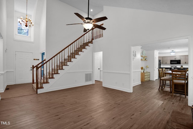 7832 Shuttle Rd, Fayetteville, NC 28311 - entrance foyer with high vaulted ceiling, stairway, dark wood-type flooring, a ceiling fan, and a chandelier