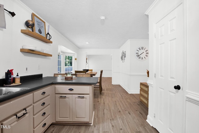 7832 Shuttle Rd, Fayetteville, NC 28311 - kitchen with a peninsula, dark countertops, open shelves, light wood finished floors, and a textured ceiling