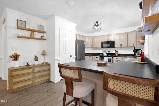 7832 Shuttle Rd, Fayetteville, NC 28311 - kitchen with stainless steel appliances, open shelves, dark countertops, a peninsula, and light wood finished floors