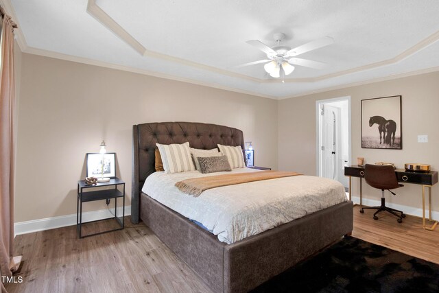 7832 Shuttle Rd, Fayetteville, NC 28311 - bedroom with light wood-style flooring, a raised ceiling, and ornamental molding