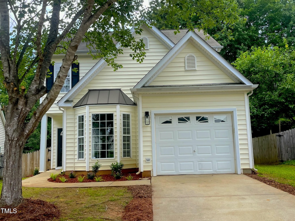 2409 Valley Haven Dr, Raleigh, NC 27603 - view of front of property featuring concrete driveway, a garage, and a standing seam roof