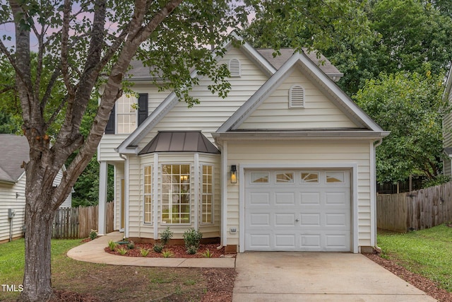 2409 Valley Haven Dr, Raleigh, NC 27603 - view of front of home with concrete driveway, a garage, and a standing seam roof