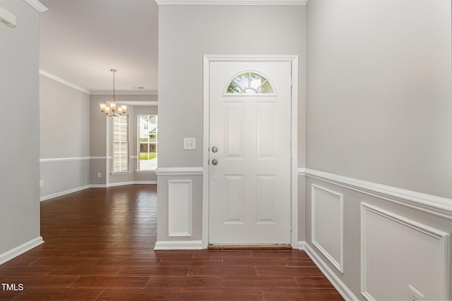 2409 Valley Haven Dr, Raleigh, NC 27603 - foyer entrance with a chandelier, dark wood-style floors, and ornamental molding