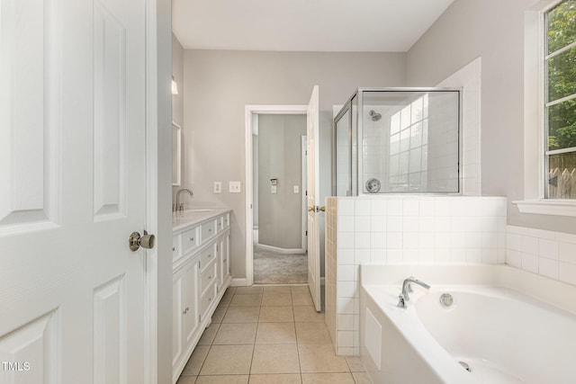 2409 Valley Haven Dr, Raleigh, NC 27603 - full bath featuring vanity, a garden tub, a shower stall, and tile patterned floors