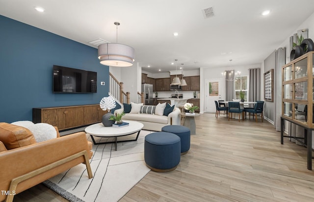 4028 Kidd Pl, Durham, NC 27703 - living area with light wood-style floors, recessed lighting, stairway, and a chandelier