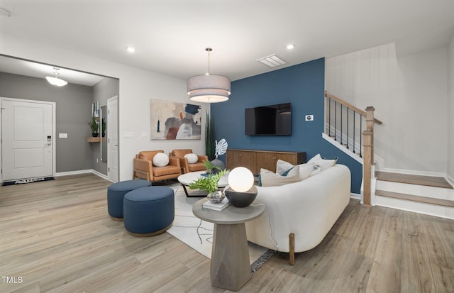 4028 Kidd Pl, Durham, NC 27703 - living area with wood finished floors, stairway, baseboards, and recessed lighting