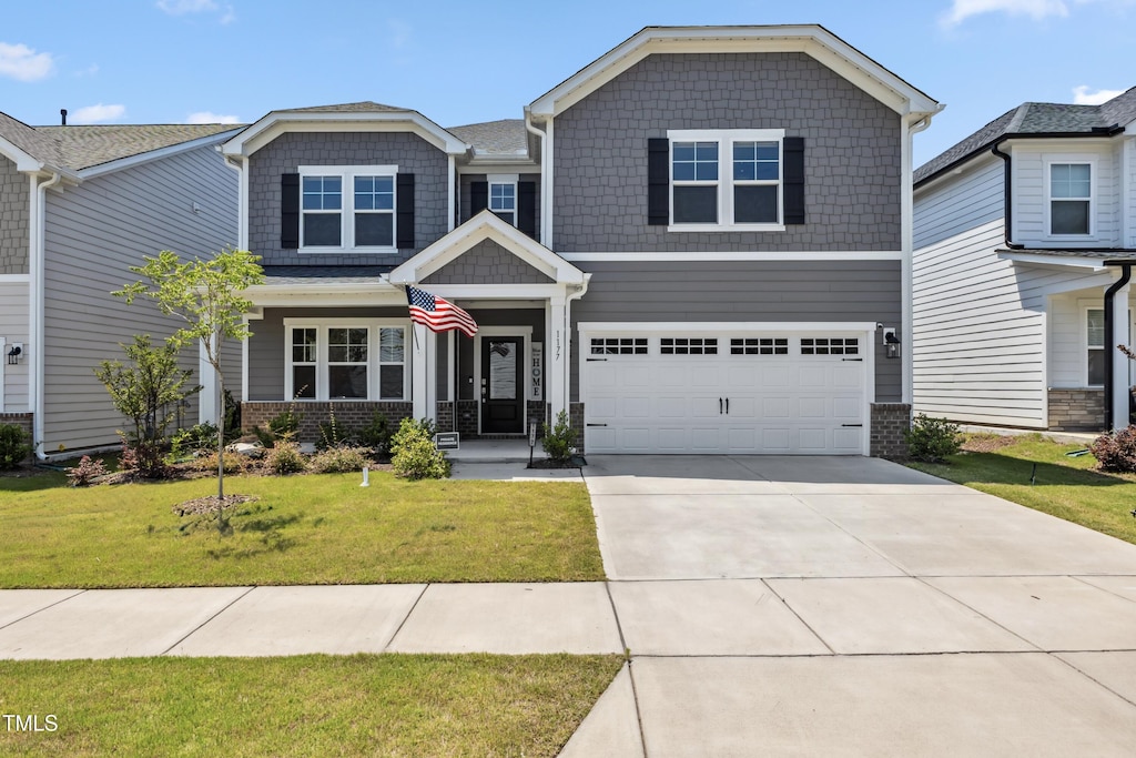 1177 Sun Springs Rd, Wake Forest, NC 27587 - craftsman inspired home featuring concrete driveway, a garage, a front yard, and brick siding