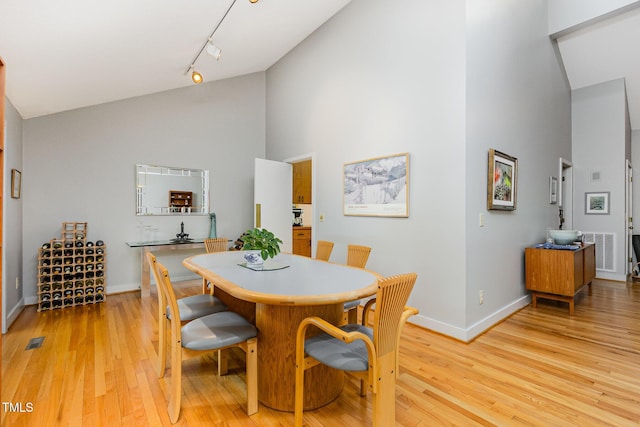 6 Womble Cir, Durham, NC 27705 - dining room with high vaulted ceiling, track lighting, and light wood-style flooring