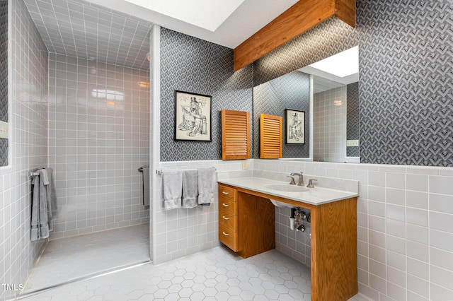 6 Womble Cir, Durham, NC 27705 - bathroom featuring tile walls, tile patterned floors, tiled shower, and wainscoting