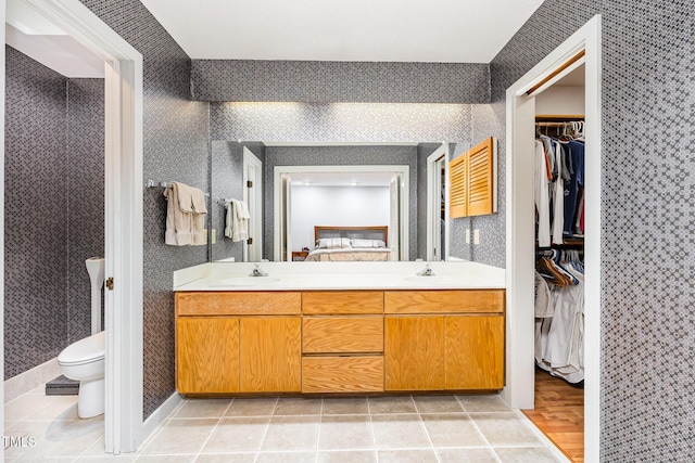 6 Womble Cir, Durham, NC 27705 - bathroom with double vanity, a walk in closet, and tile patterned flooring