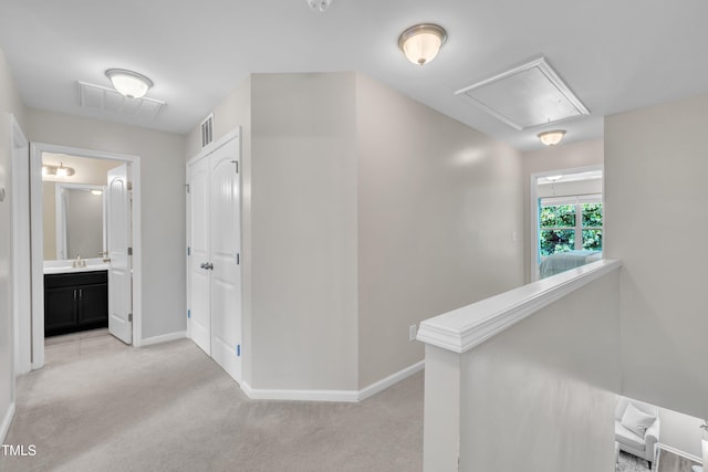 342 Westgrove Ct, Durham, NC 27703 - corridor with attic access, light carpet, an upstairs landing, and baseboards