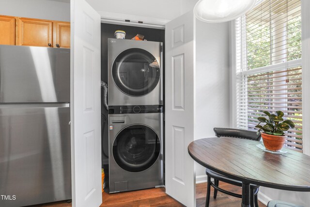 412 Heritage Village Ln, Apex, NC 27502 - washroom featuring estacked washer and dryer and dark wood finished floors