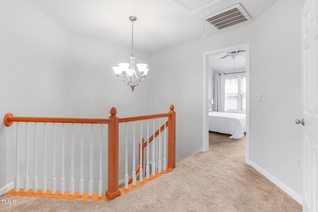 412 Heritage Village Ln, Apex, NC 27502 - hall with attic access, carpet floors, baseboards, and an upstairs landing