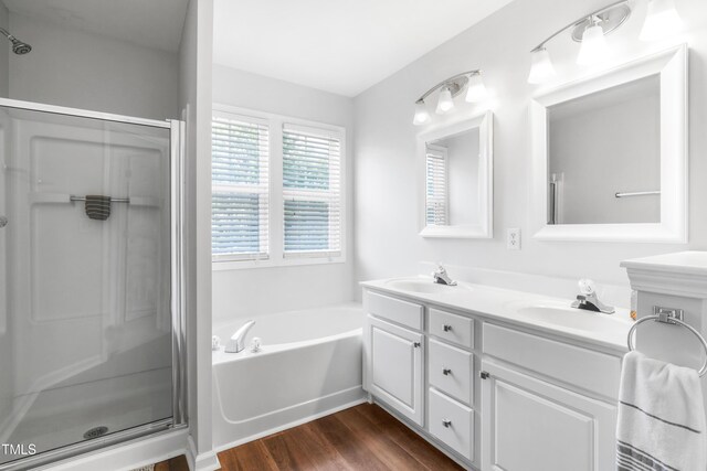 412 Heritage Village Ln, Apex, NC 27502 - bathroom featuring a shower stall, double vanity, a bath, and wood finished floors